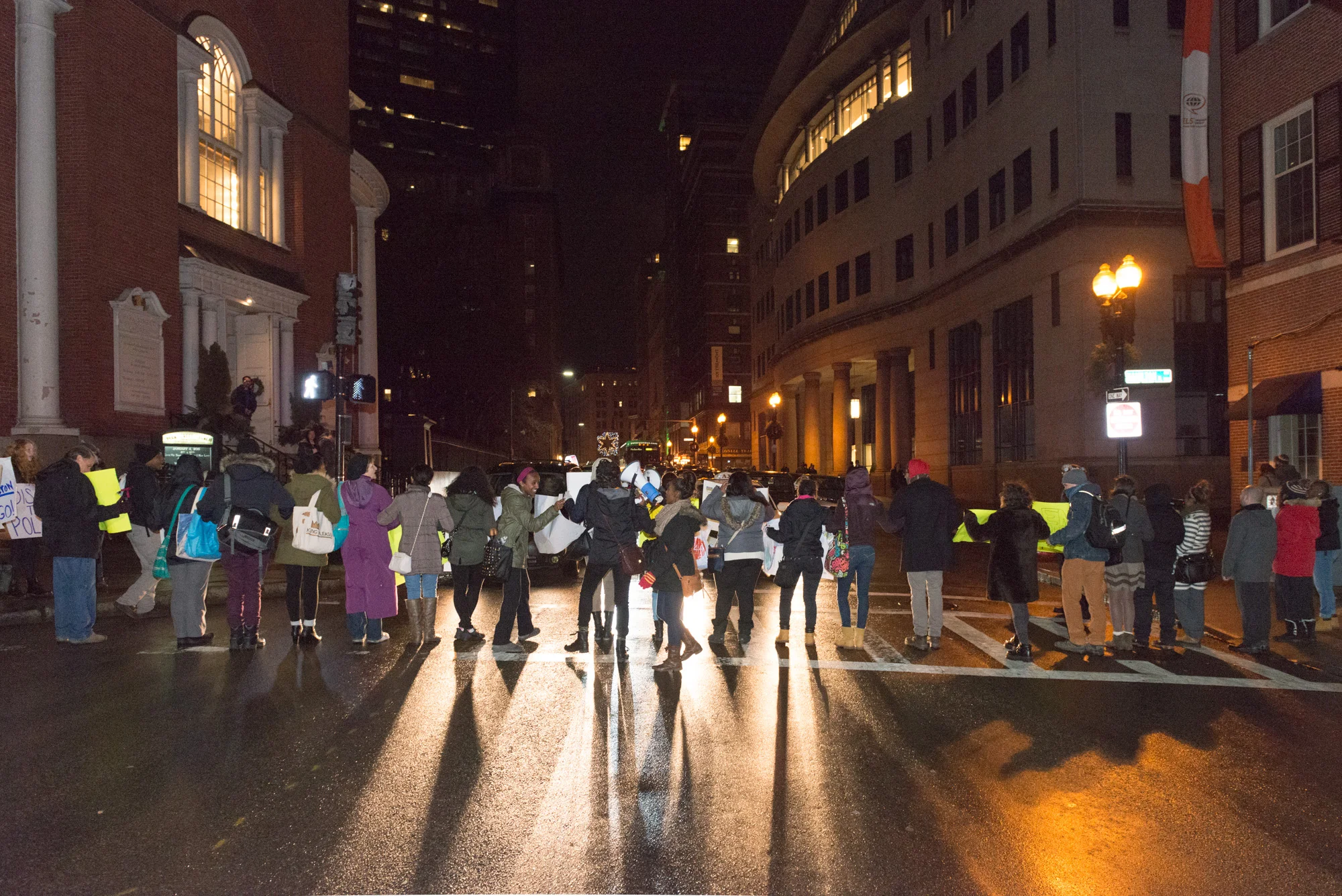 Protesters in a line blocking traffic on Tremont St.