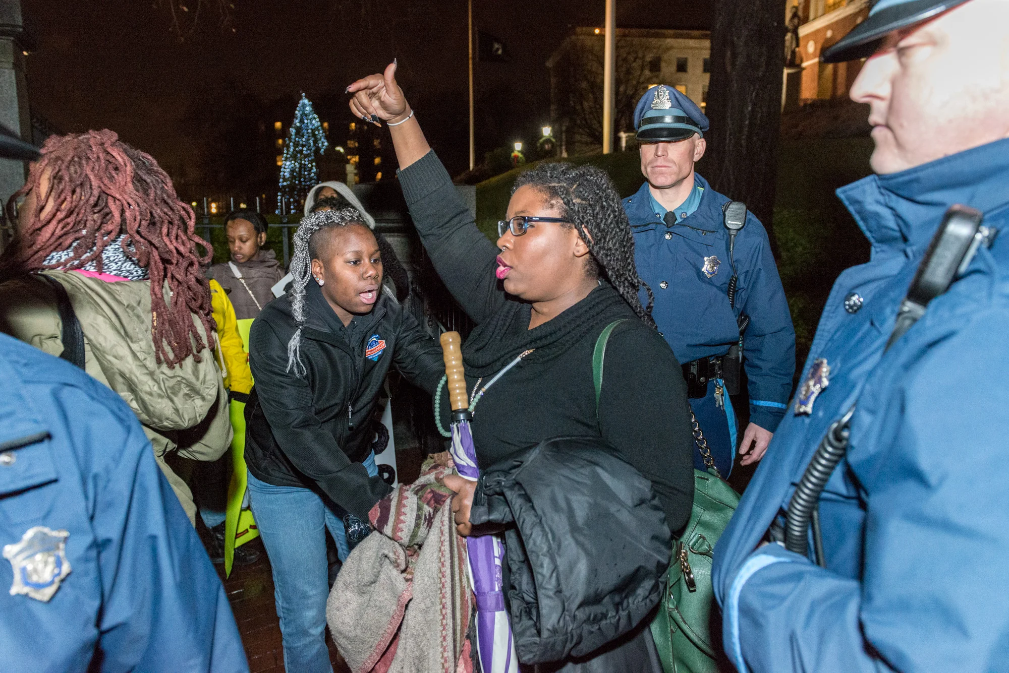 One of the protesters escorted out of the State House event