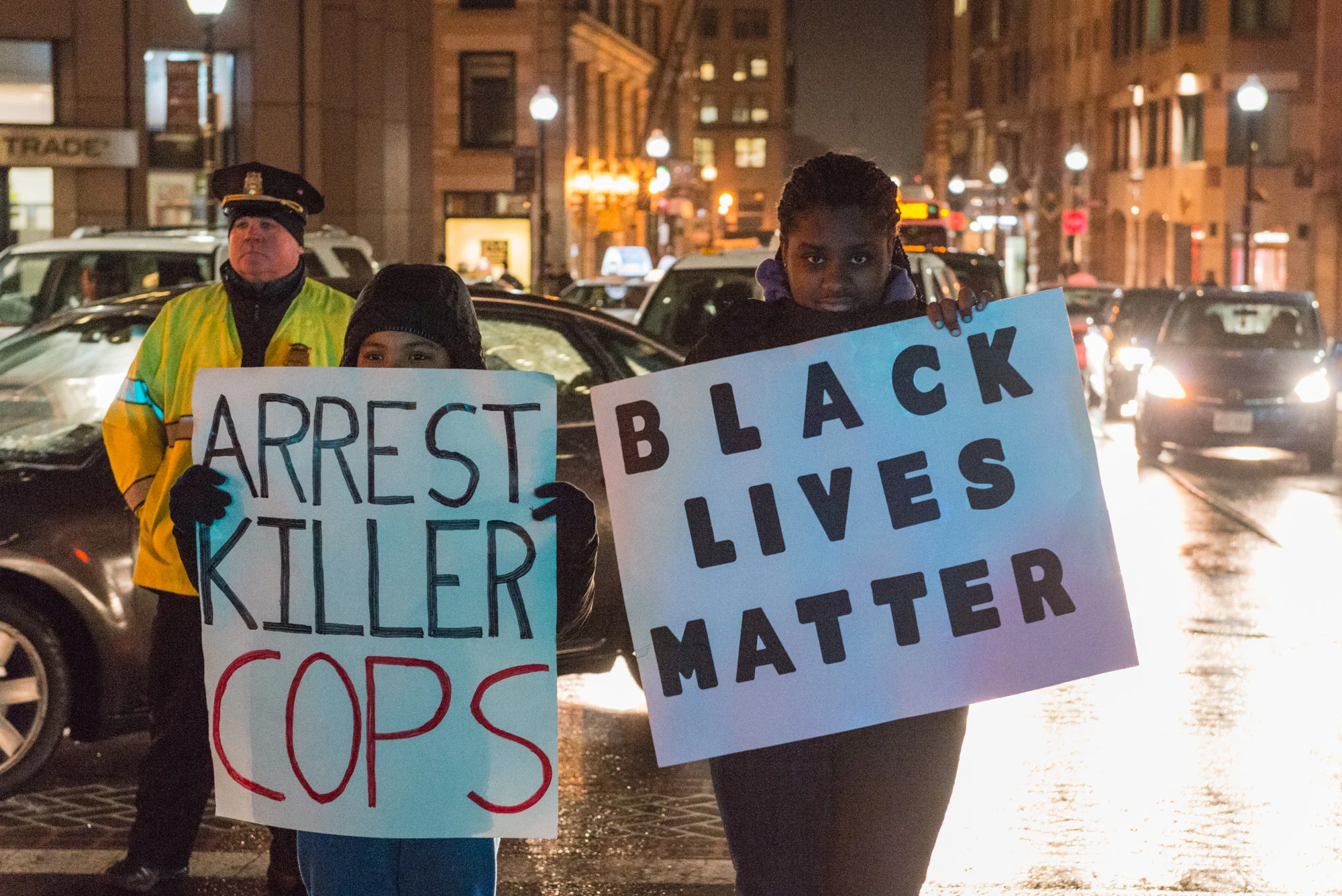 Protesters holding signs at State and Congress