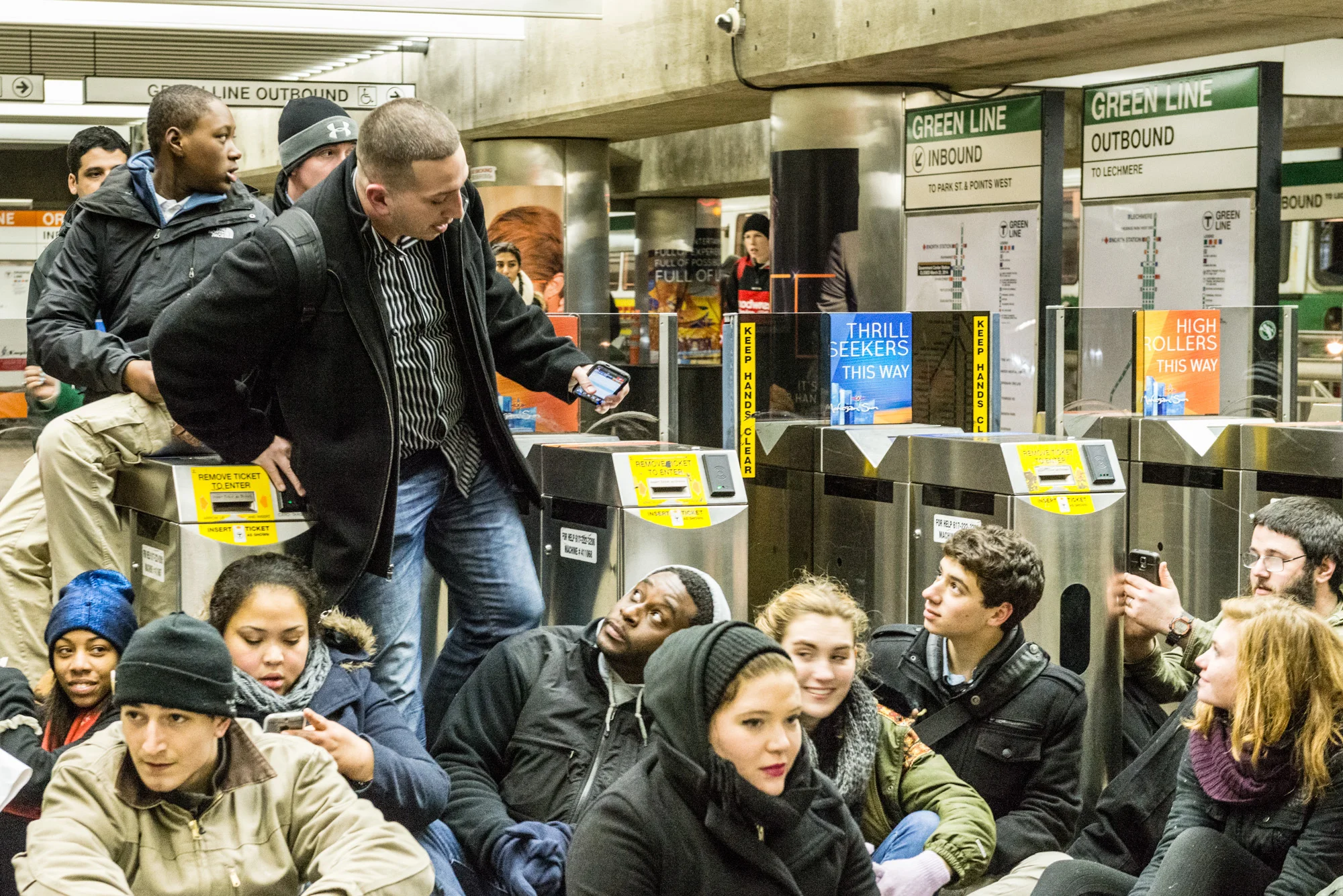 Man trying to step over a black protesters while trying the exit the station