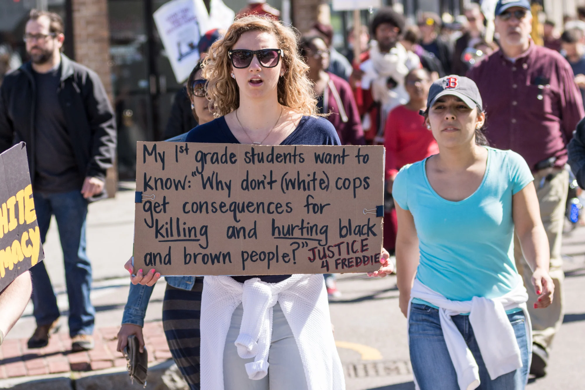 1st grade school teacher with sign