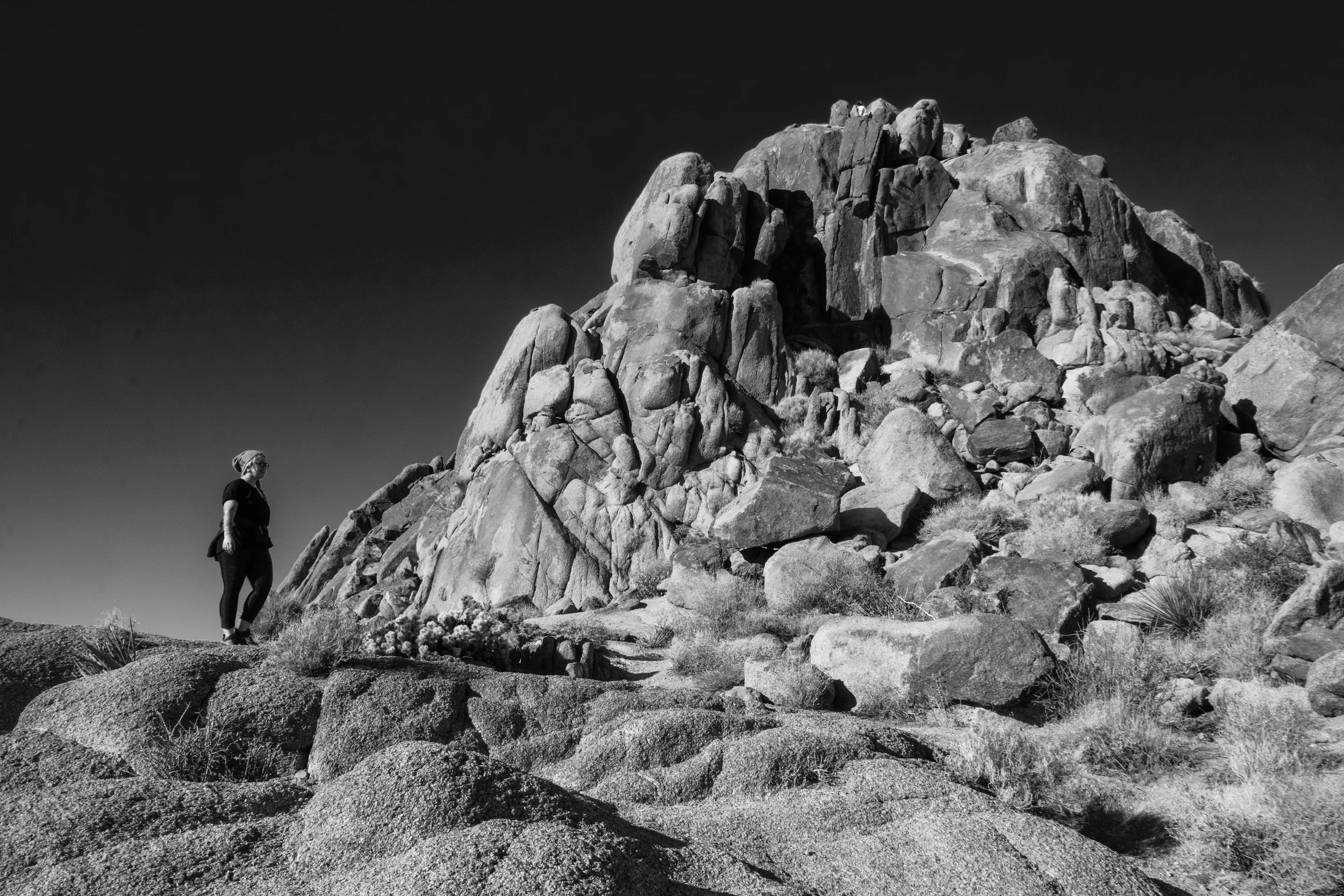 Hiker on path up to top of rock formation, Joshua Tree National Park