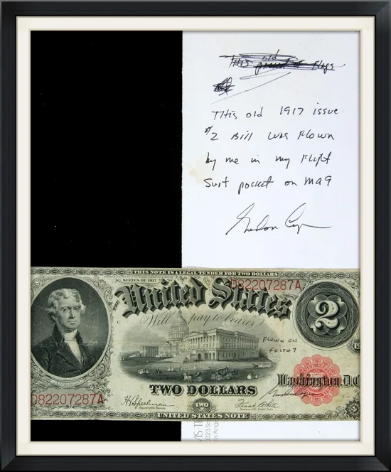 The flown bill along side the envelope in which it was housed, with Gordon Cooper's flight certification on the bill and the envelope. According to the envelope and the note, written in Cooper's own hand, this particular bill was folded and stored in his flight suit pocket for the flight.