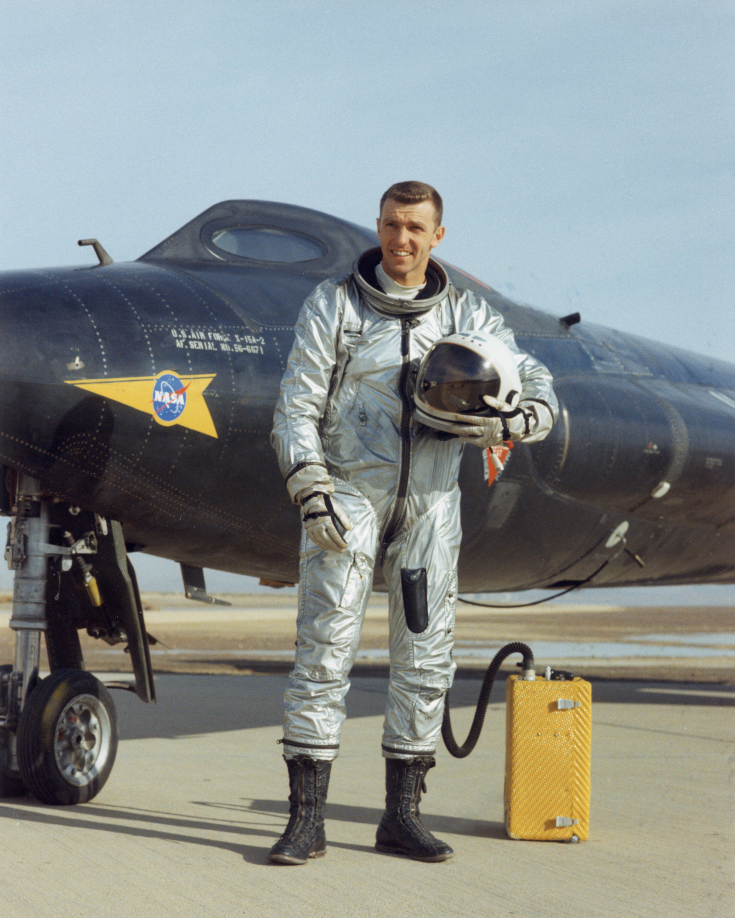 Test pilot Joe Engle in his David Clark Company pressure suit standing in front of the X-15 rocket plane.