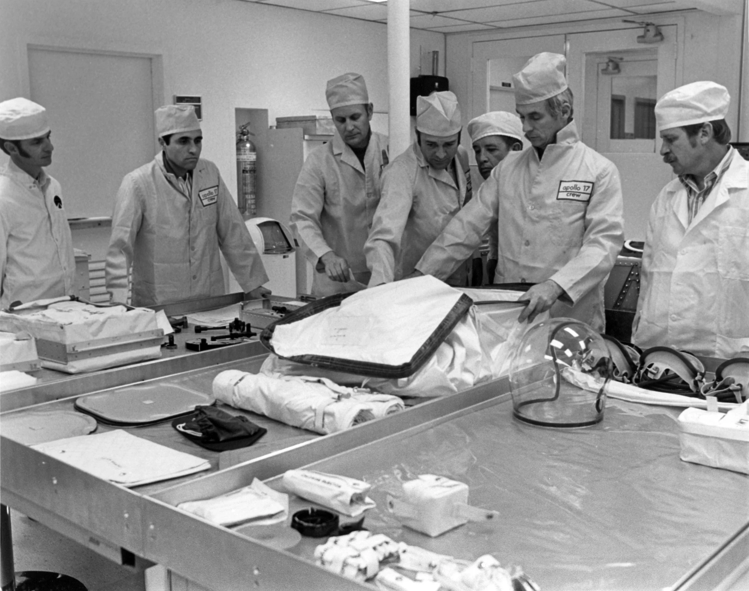A rare photo of Bob Horne and his team discuss the stowage of crew equipment and personal items with the Apollo 17 crew. Bob is standing between A17 CMP Ron Evans, and CDR Gene Cernan.