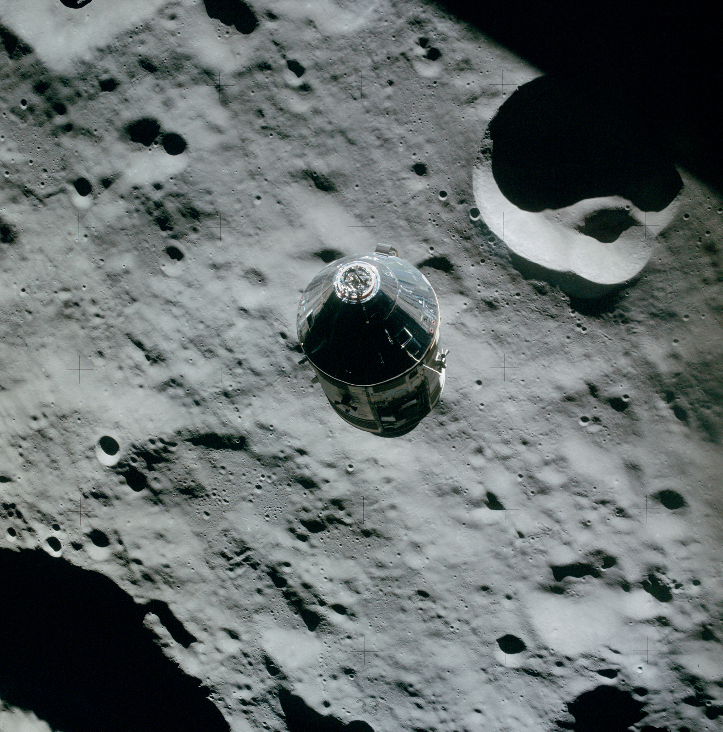 Apollo 16 Command Module "Casper" during one of its 64 orbits of the moon, as photographed from Apollo 16 lunar module "Orion." Aboard Casper, tucked carefully among the crew's PPKs, is this series 1963, red seal $2 bill, S/N A02317535A,