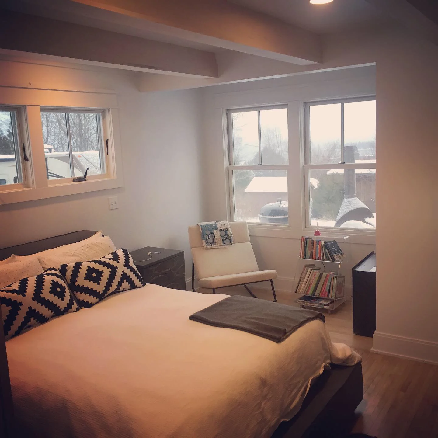 The master bedroom features his and hers closets, and a sunny alcove for sitting and overlooking the big lake. Floors are refinished birdseye maple from 1935 and maple beams help add interest and stlye to the ceiling.