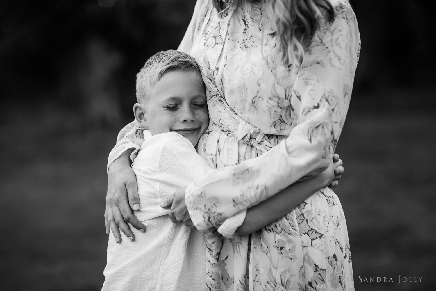 black-and-white-photo-of-boy-hugging-mom-by-sandra-jolly-photography.jpg