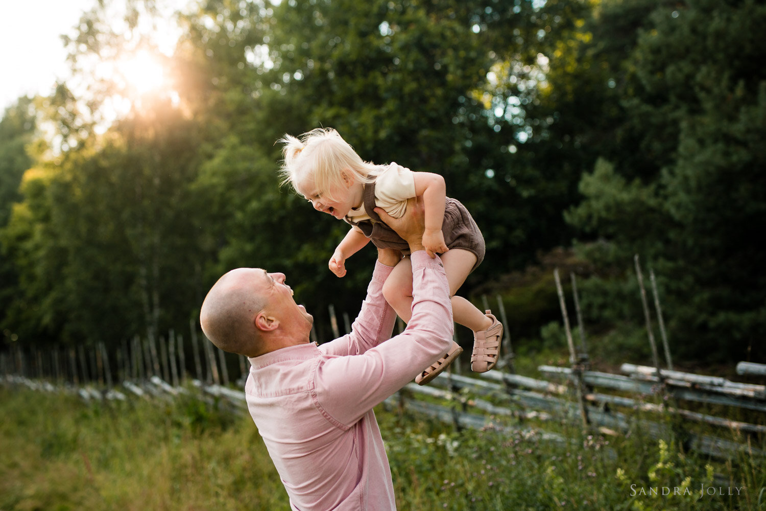 father-holding-daughter-in-the-air-by-sandra-jolly-photography.jpg