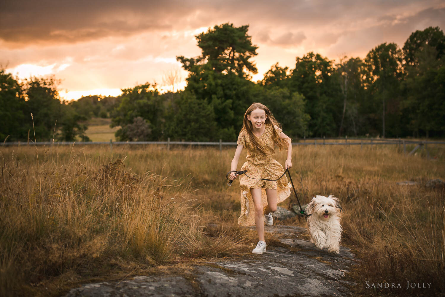 girl-running-with-her-dog-in-field-by-sandra-jolly-photography.jpg