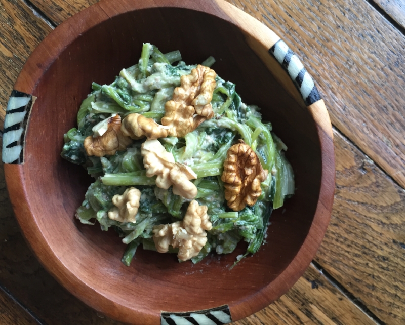 When buying bagged spinach, we are paying for someone to clean the spinach and throw away the stems for us. It's expensive and a waste. Spinach stems are delicious in this Sephardic salad with walnut and garlic sauce. 