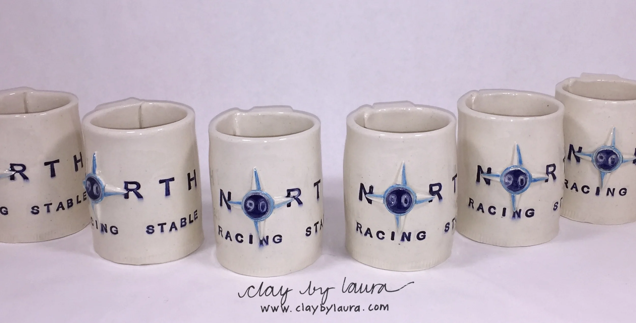 This set of mugs uses a company logo as the basis for the decoration and colors. It took a couple of tries to get this commission to completion, but that's part of the process!