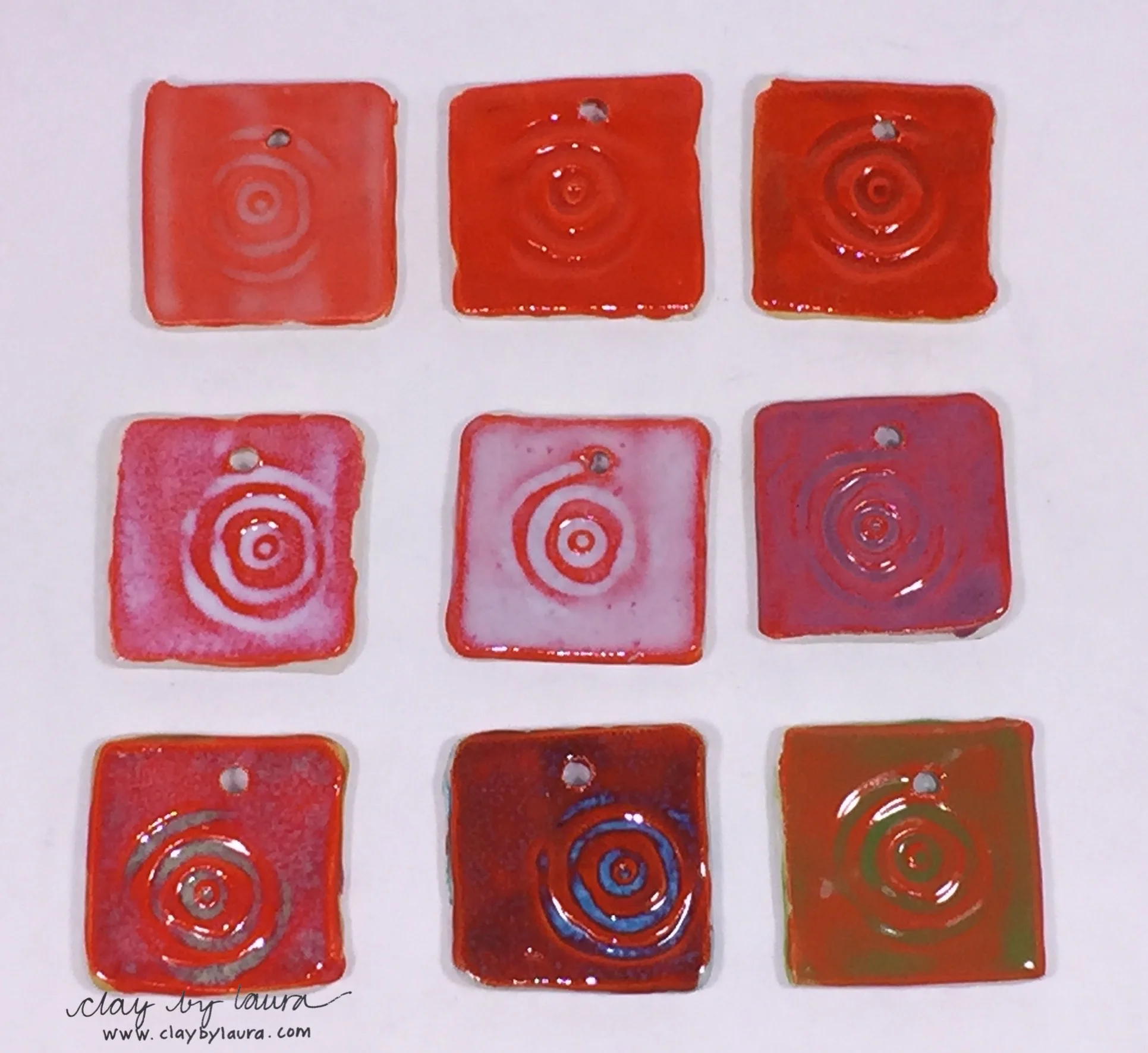 The orange base color of these test tiles takes on a different look depending on the top layer of glaze color that is applied. 