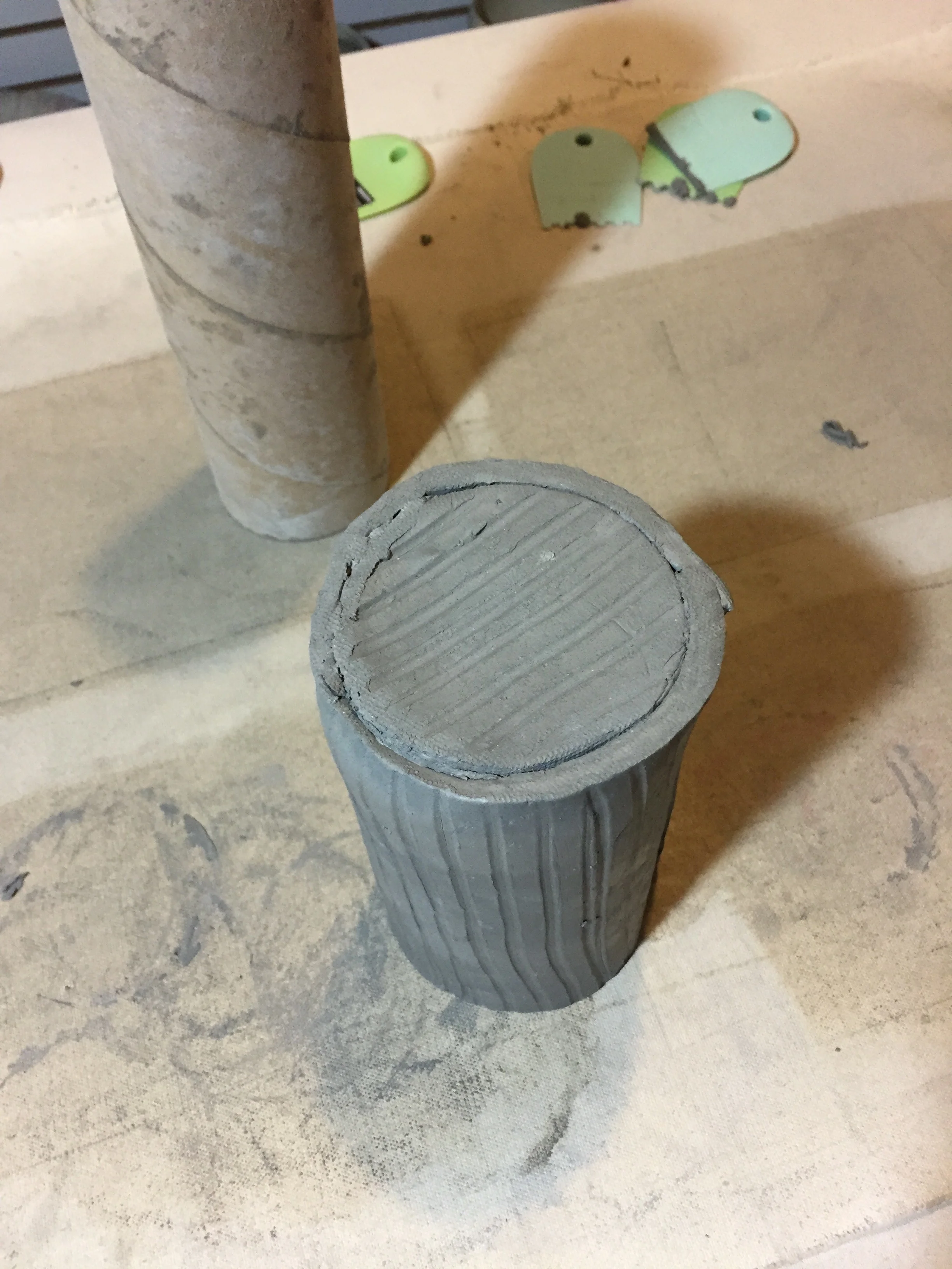 Once I've attached the bottom, I flip the piece to secure it properly. I use a sponge to compress the joint and make sure there are no gaps on the outside or inside of the pot. 
