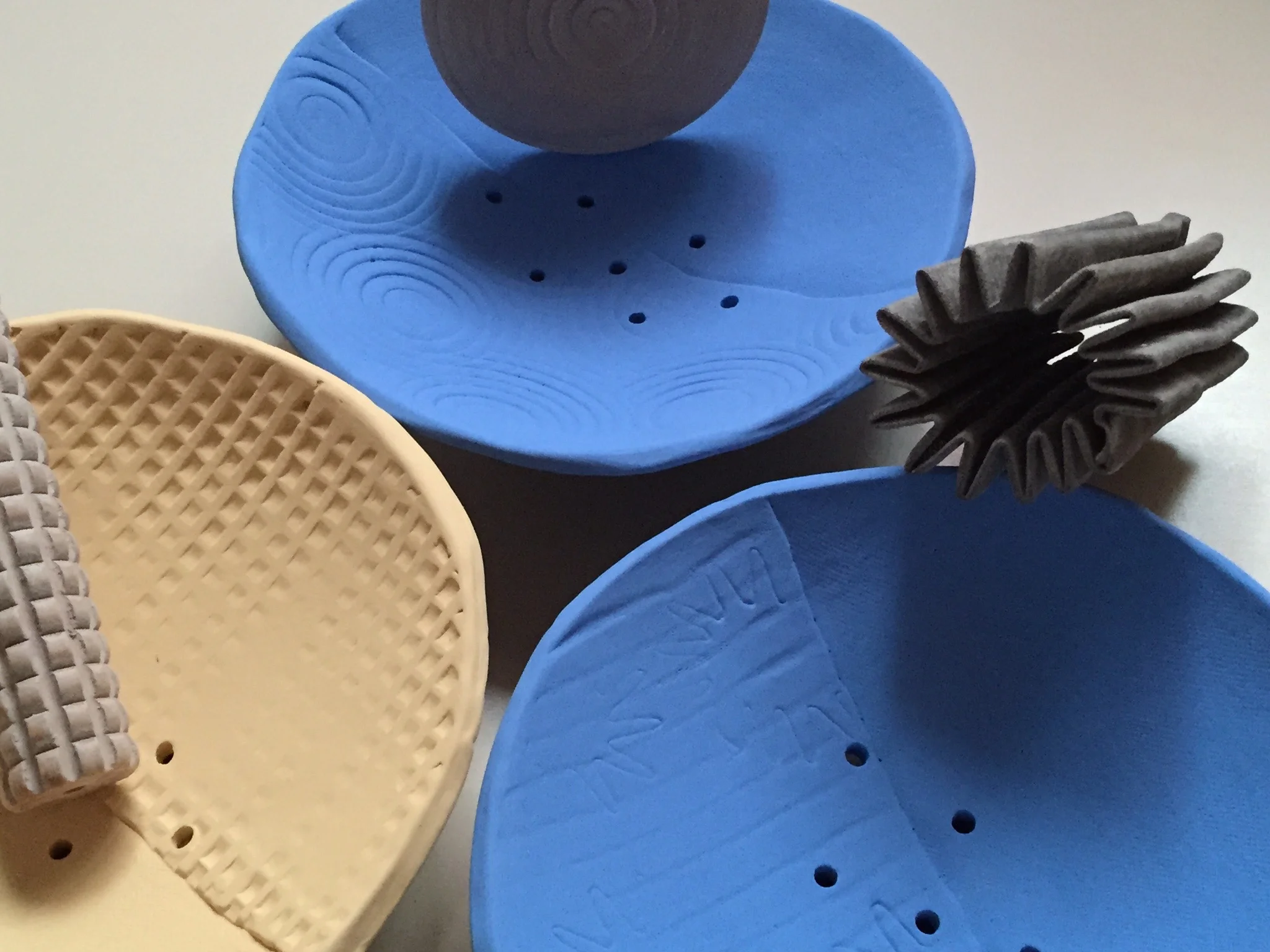 I've used some of my favorite pattern-makers here to create some interest in these underglazed berry bowls. When I am working on a series of pieces, I often make snap-decisions on which tools I'll use to emboss the clay. 