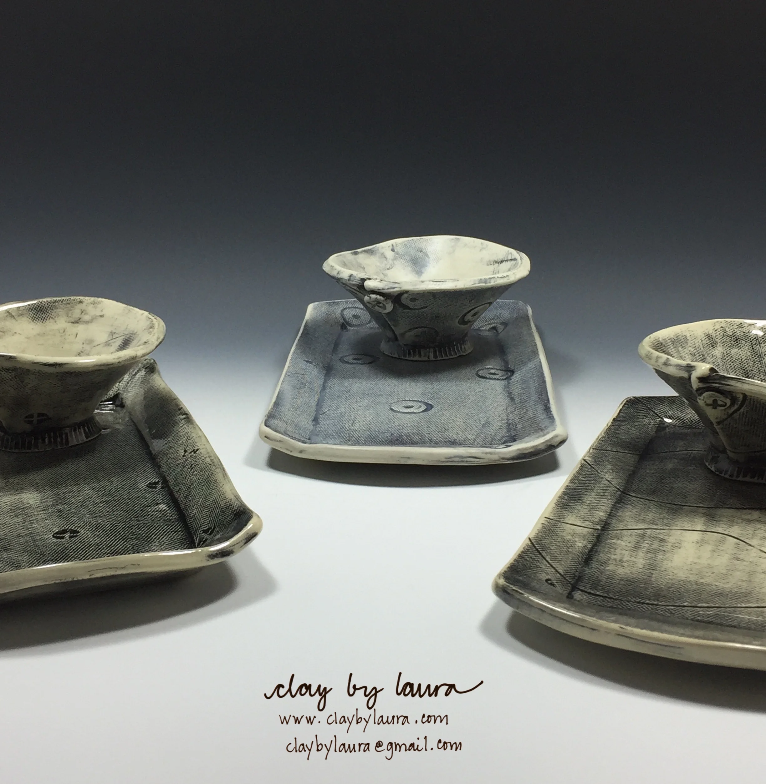 I've been experimenting with the use of a single color on my pieces. I apply an underglaze to the clay before it is fired and use a wet sponge to wipe some away. After it is fired once, I apply a clear glaze with either a shiny or matte finish. I like how the color pools in the stamped areas as well as showing the marks of the canvas I use to flatten the clay in the slab roller. I feel this portrays the making process in every finished piece.