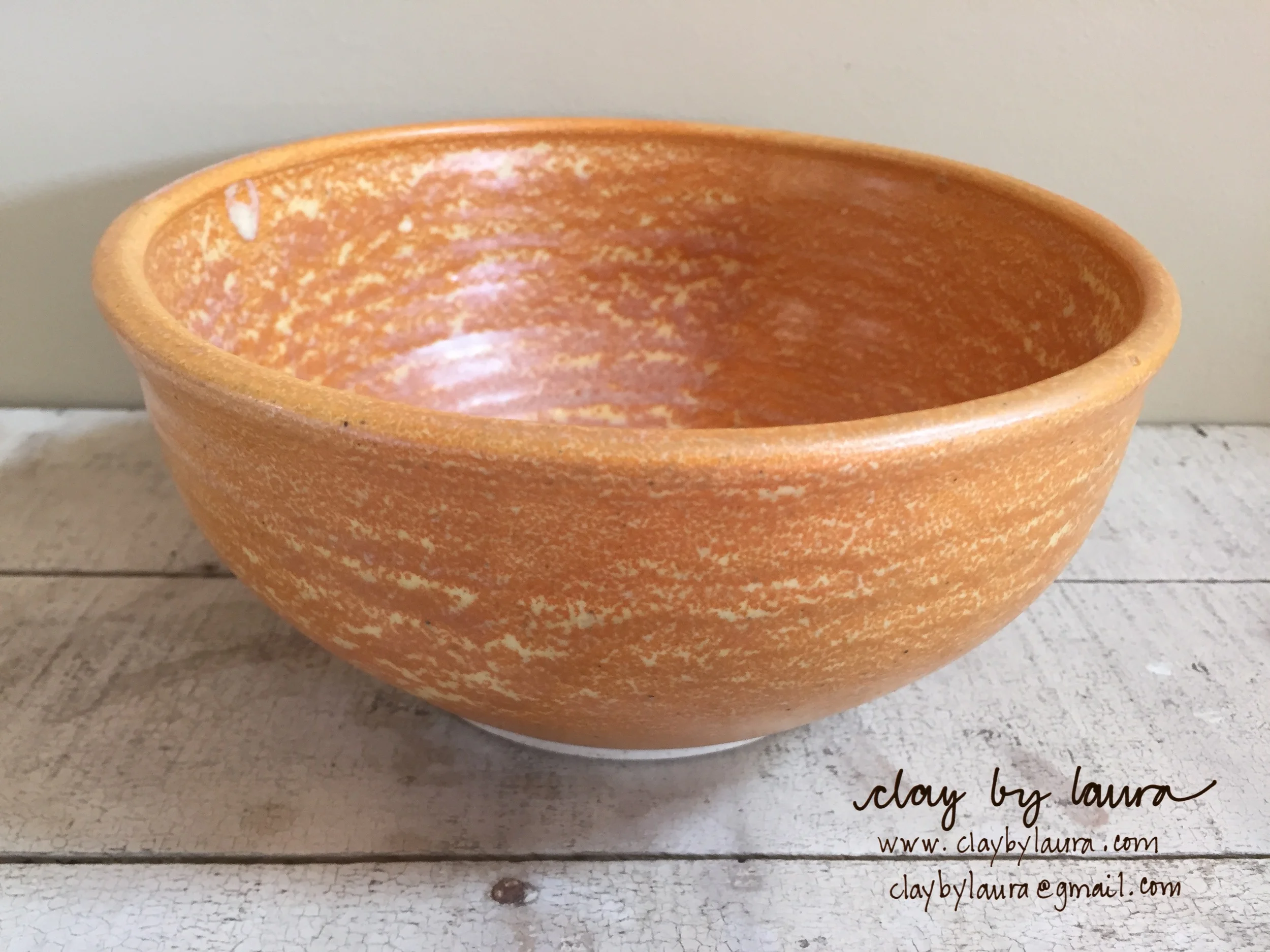 I made this bowl in 2002 when I was using the potters wheel and a different glaze technique at a community studio. It was one of the few 'bright' colors available. It's the perfect serving size for any side dish I've made for a meal.