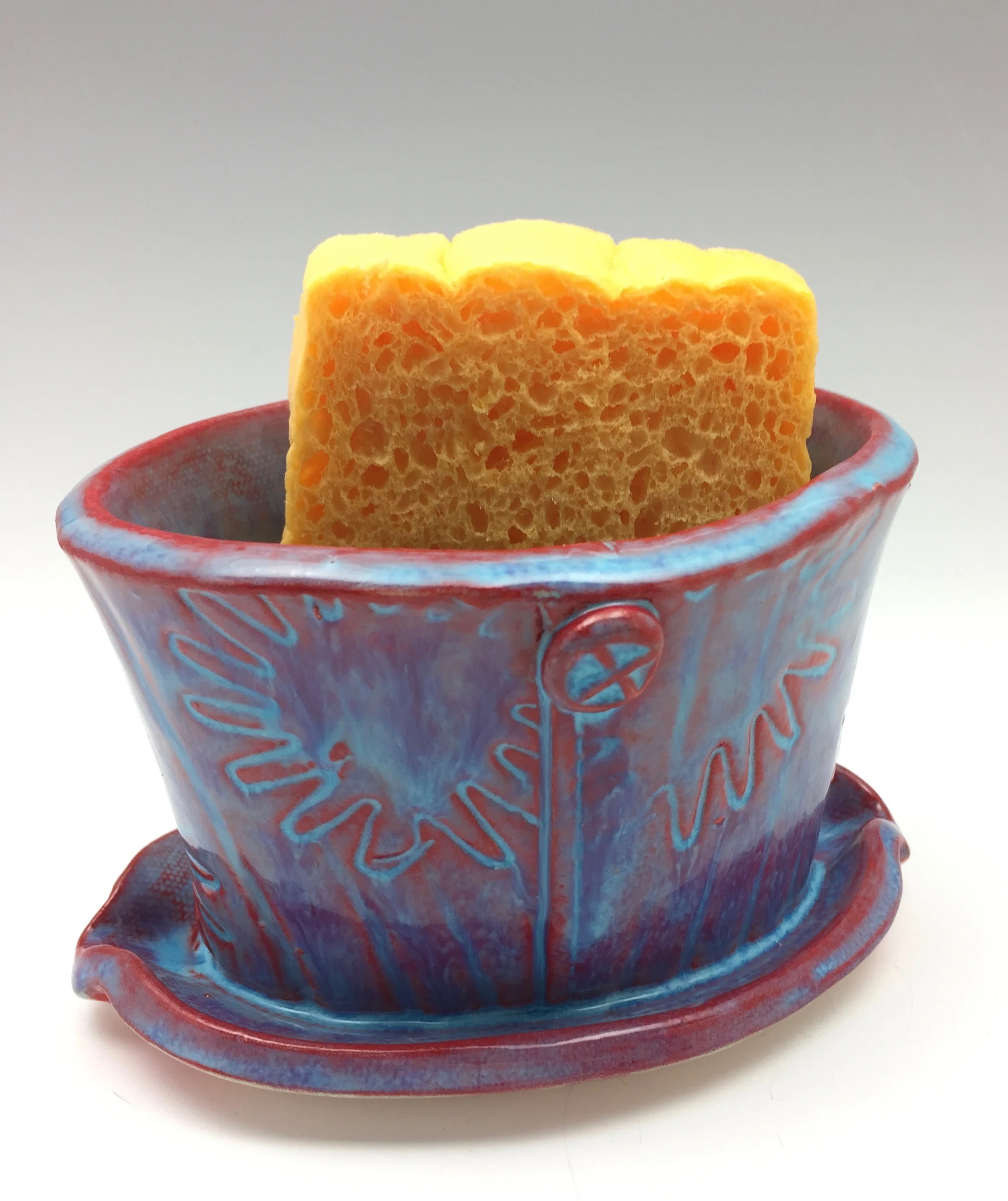 Here's a gift people may not know they need -- but will treasure once it's put to use! This oval caddy can hold a wet sponge (included!) next to the sink. The drainage air holes at the base allow it to dry easily. It also doubles as a small succulent plant container. Need something unusual for a person that is hard to shop for? This just might do the trick! Click on photo to shop!