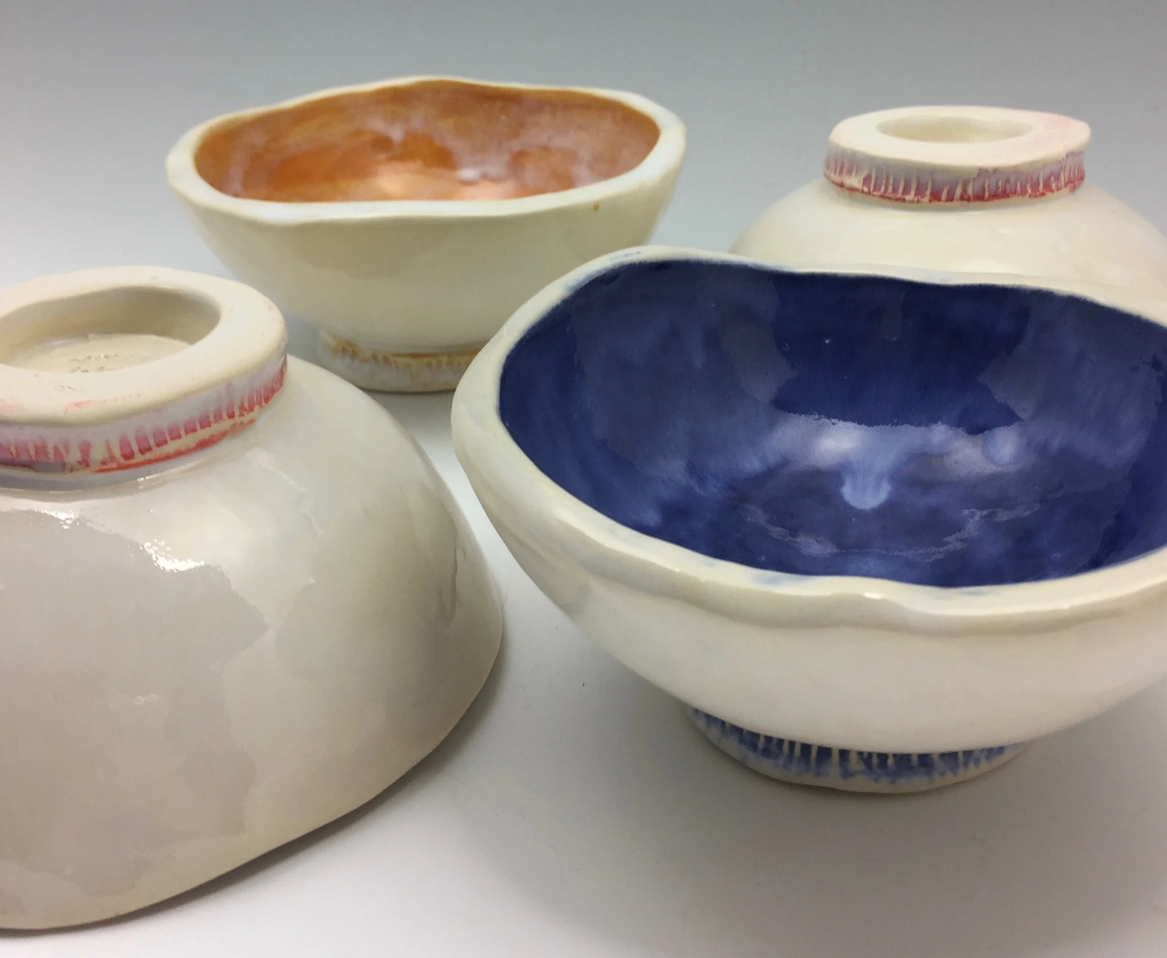 This group of bowls is accompanying a dinner set on its way to California. I experimented and accented each foot of the bowl with a pop of color. I like the results!