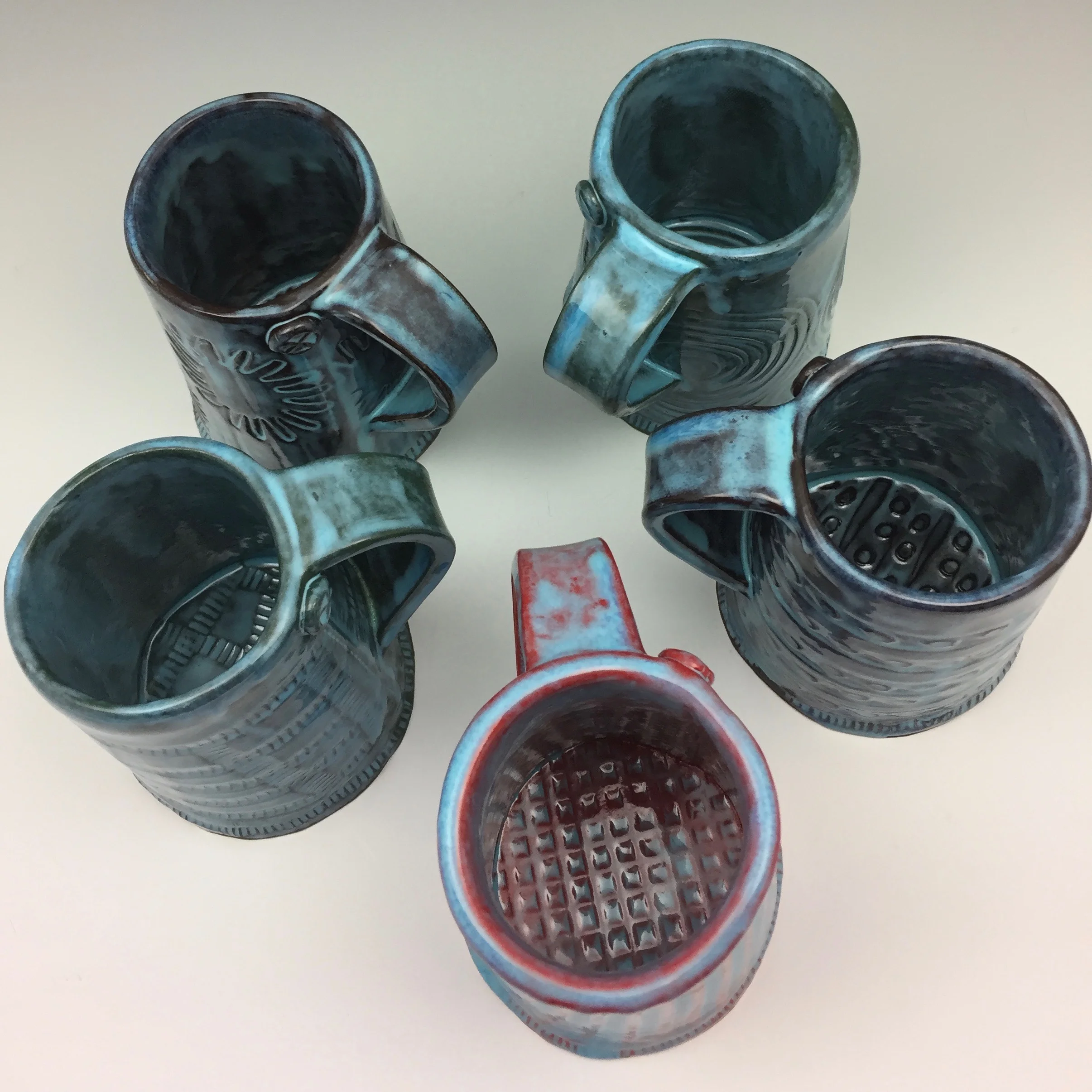 It's hard to believe the same blue glaze can look so different depending on the color that lies beneath! Here are some new mugs fresh from the kiln.