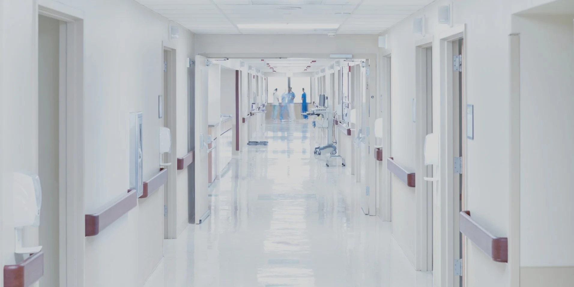 Interim Chief Financial Officer - image of hallway in hospital with nurses talking to each other at end of hallway.jpg