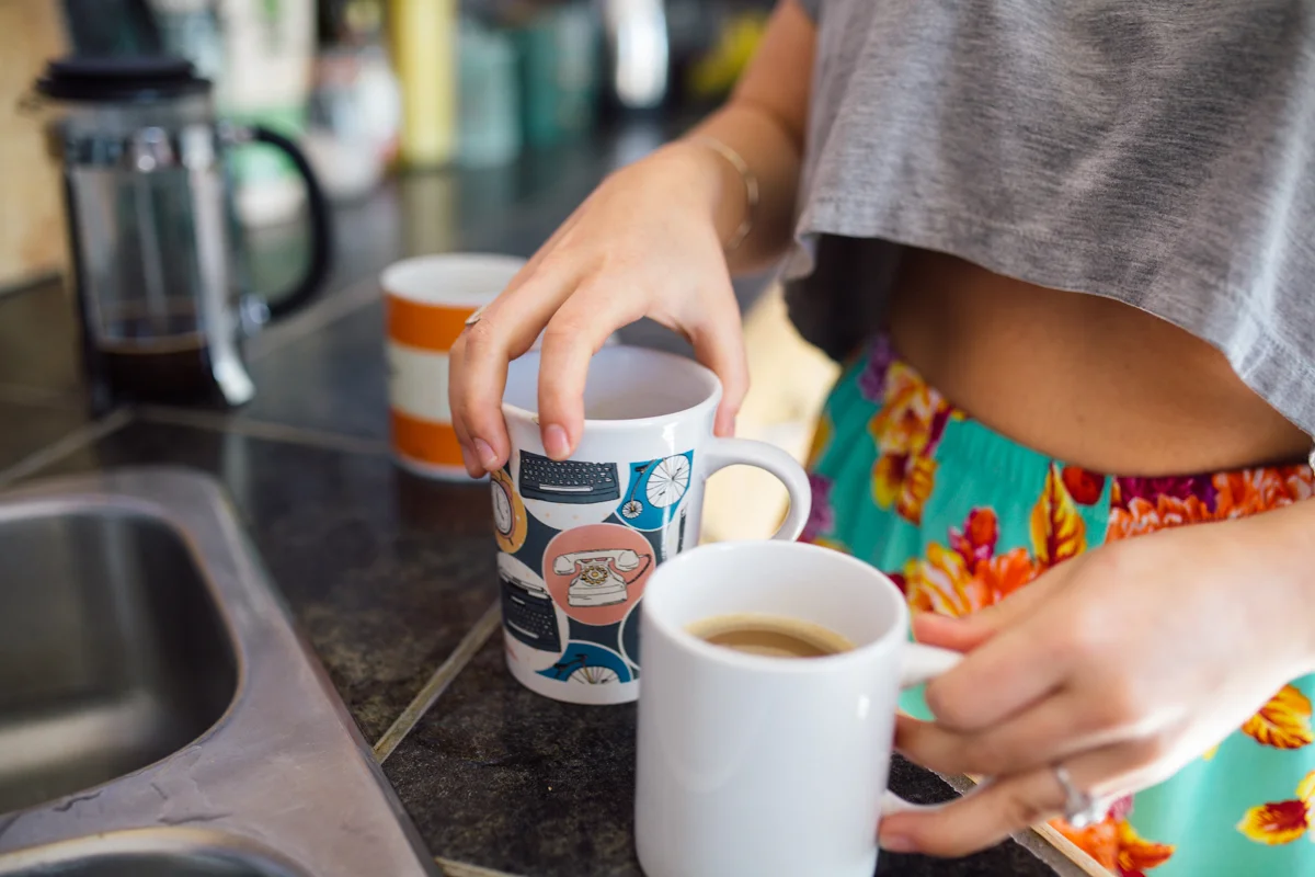 Couple starting day with a coffee at intimate at-home engagement, Victoria BC