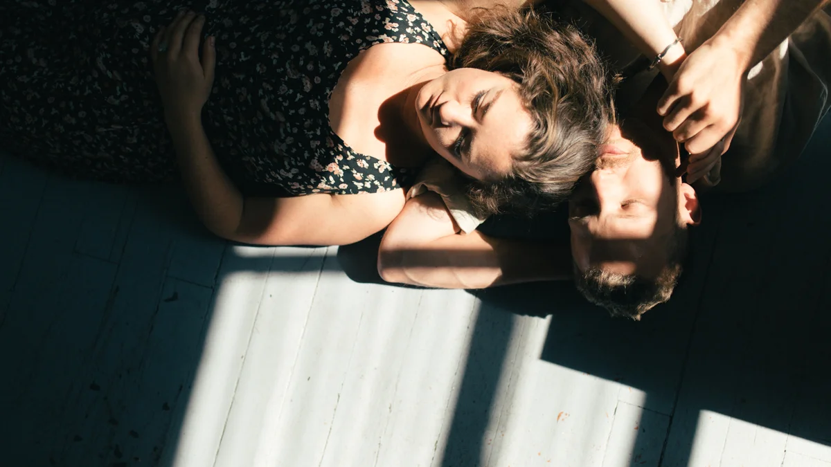 Couple lying in sunbeam intimate at-home engagement session in Victoria BC