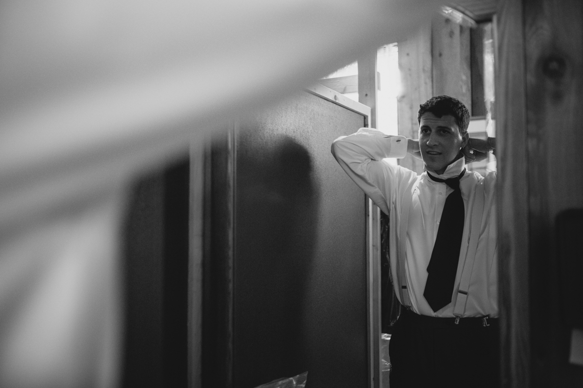 The Groom setting his tie getting ready for his wedding King Francis Park Forest Wedding Ceremony Vancouver Island