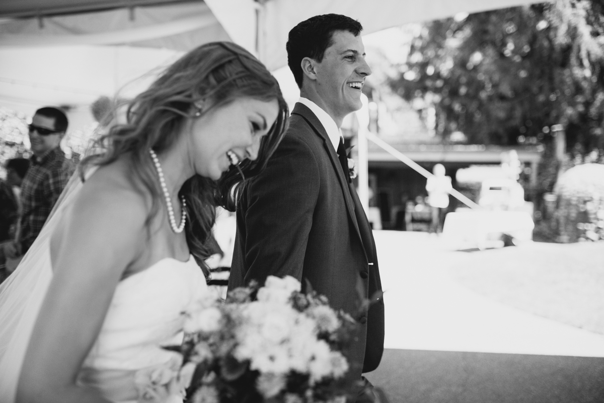 The newly wed Bride and Groom walking gleefully King Francis Park Forest Wedding Vancouver Island