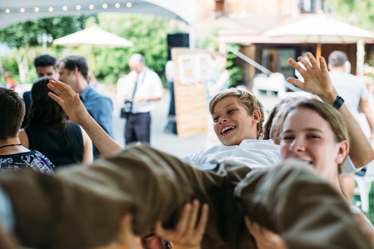 People carries a boy at the wedding reception The Guild King Francis Park Forest Wedding Vancouver Island