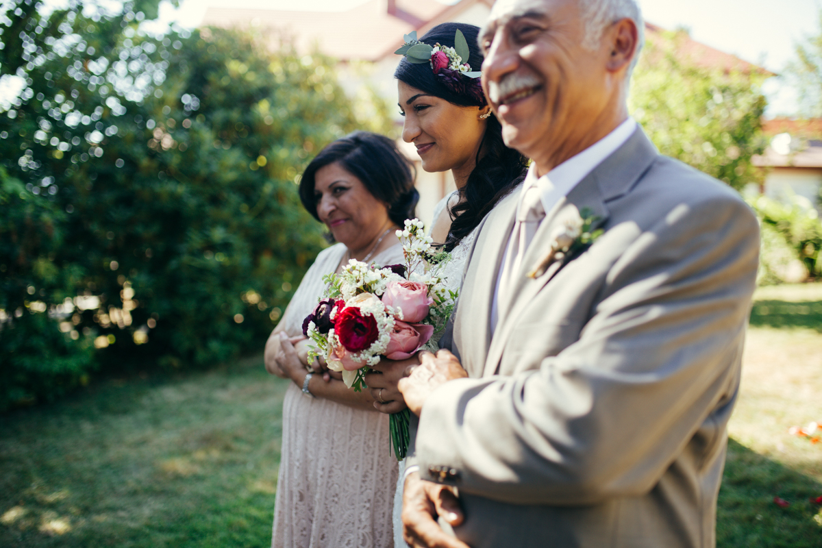 The Bride being escorted by her father and mother King Francis Park Forest Wedding Ceremony Vancouver Island