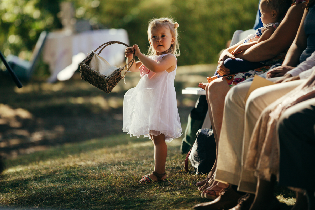 The flower girl holding her basket of flowers King Francis Park Forest Wedding Ceremony Vancouver Island