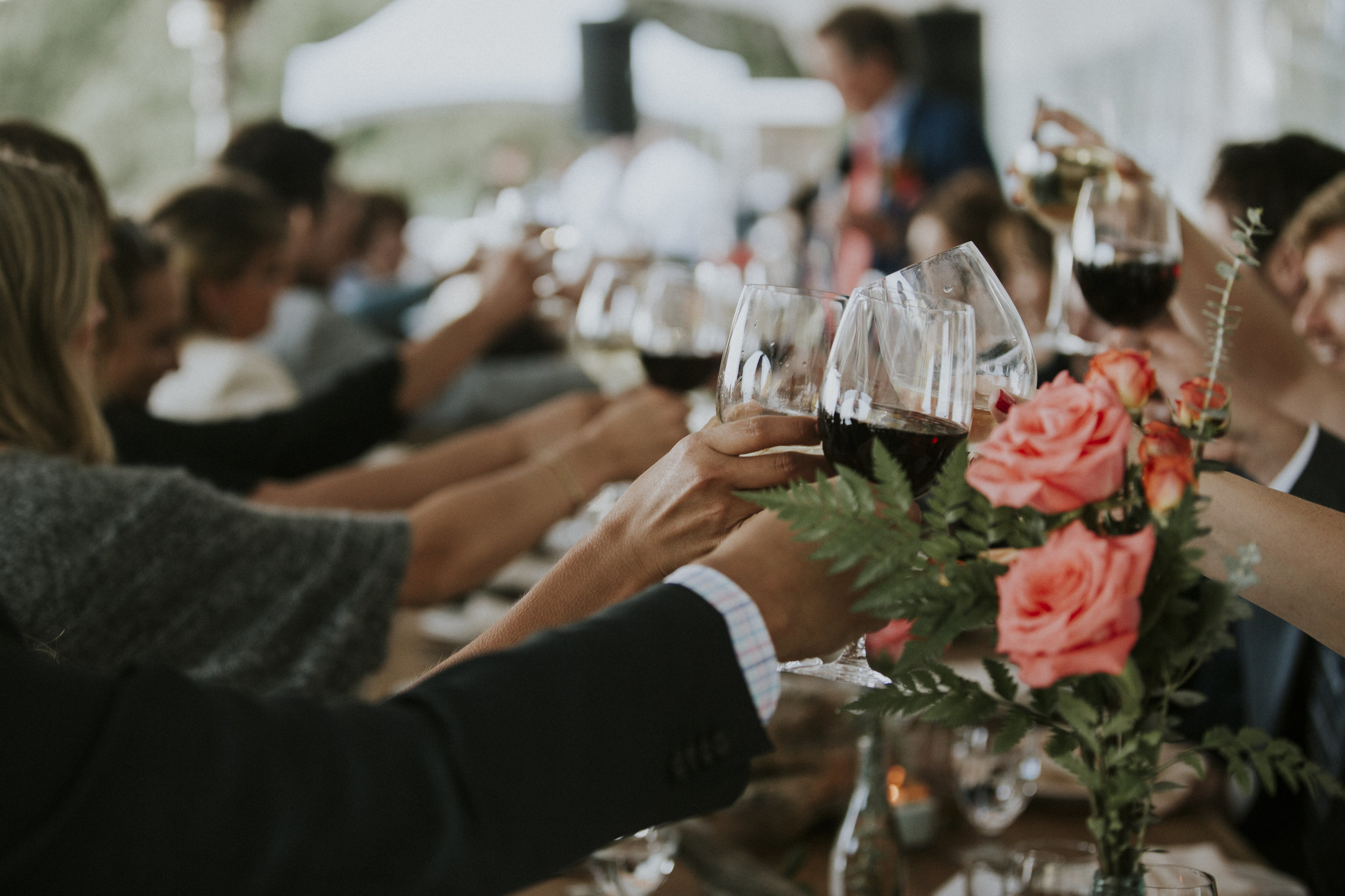 guests cheers to newly married couple at wickaninnish inn beach wedding