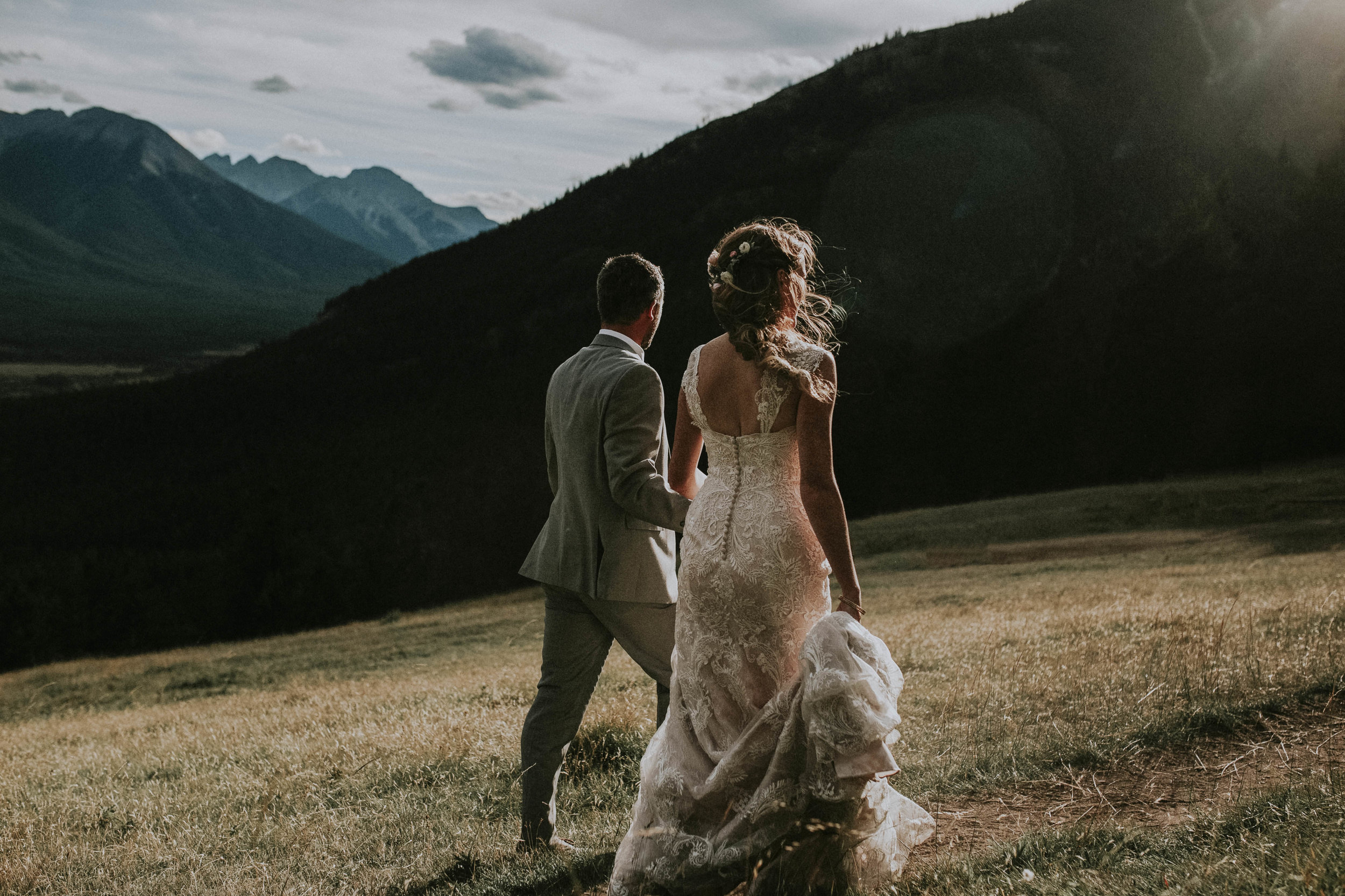 couple walks on mt norquay after wedding banff