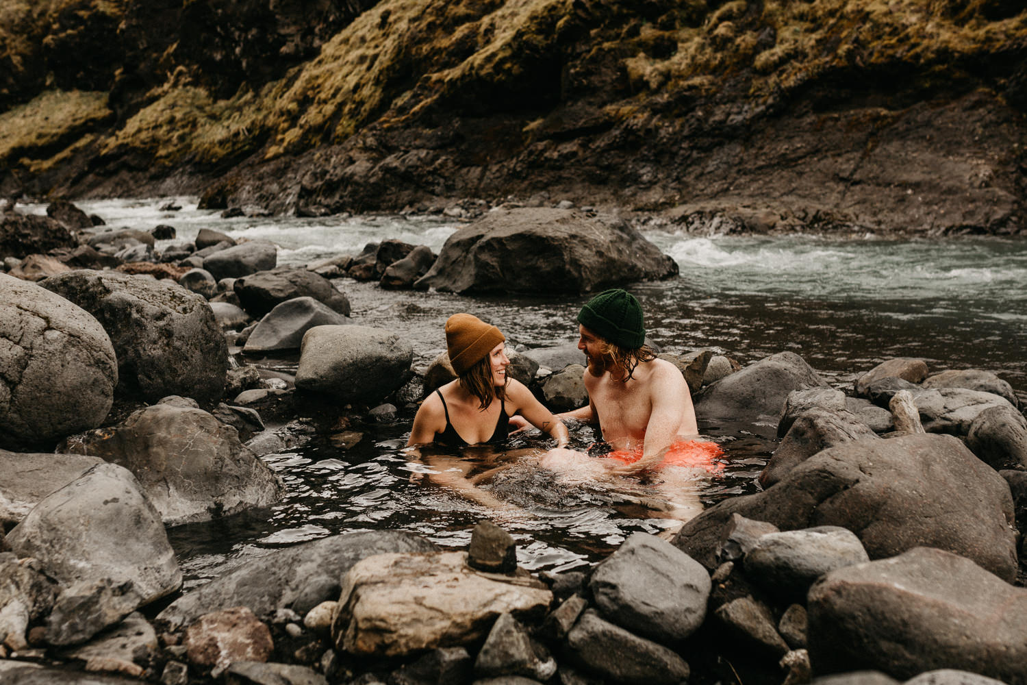 couple in hot springs iceland Seljavallalaug