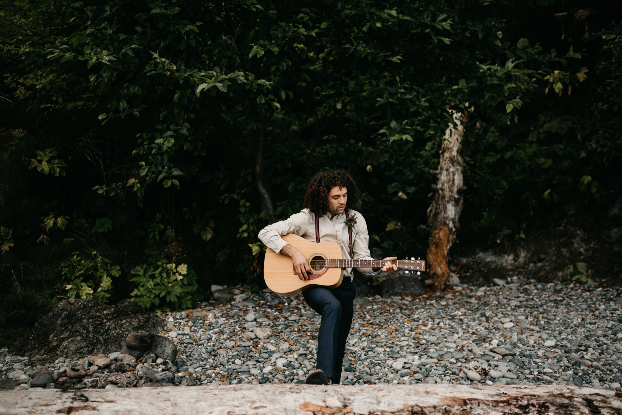 Groom plays guitar Sombrio Beach Vancouver Island wedding