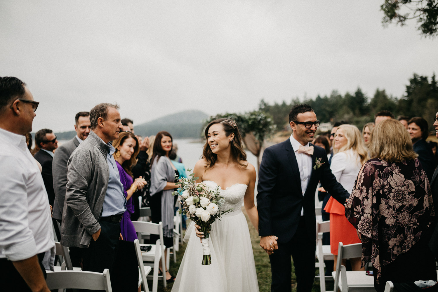Newly wed Bride and Groom walk down isle Galiano Inn Beach Wedding Ceremony