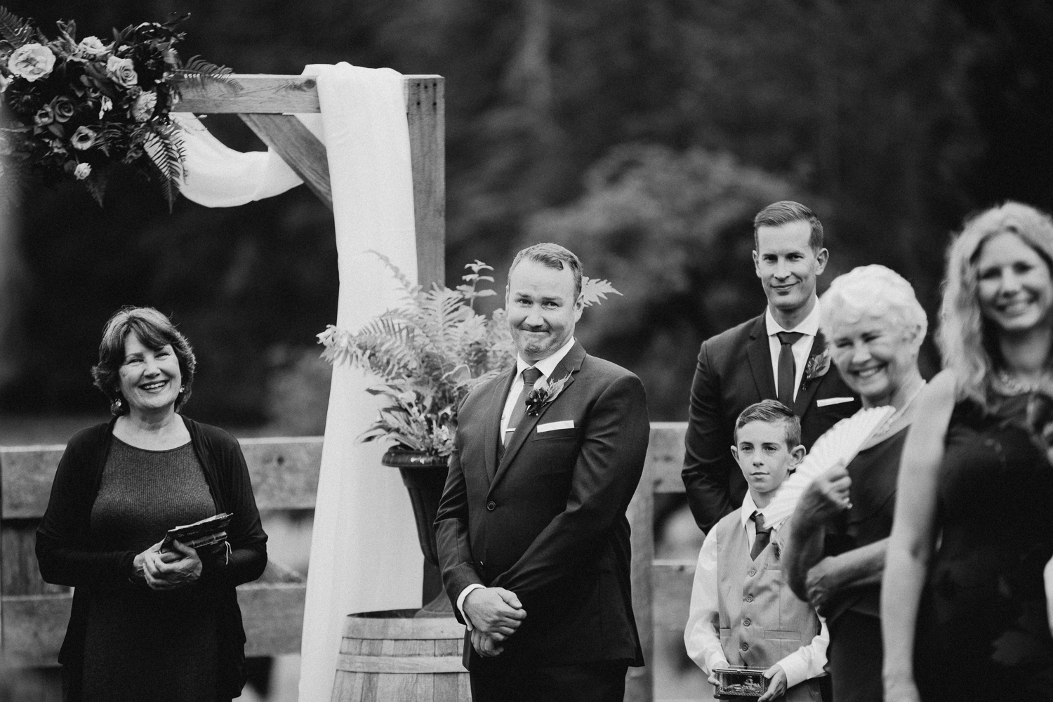 groom cries looking at bride at Bird's Eye Cove wedding, Vancouver Island