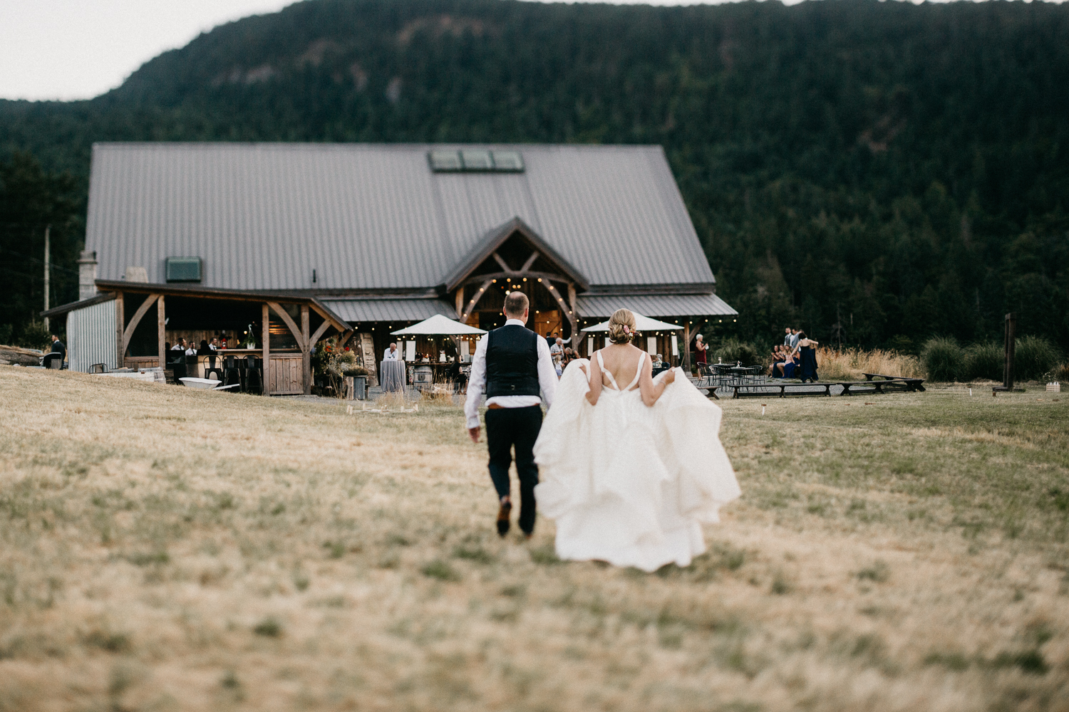 couple walks to reception at Bird's Eye Cove wedding, Vancouver Island