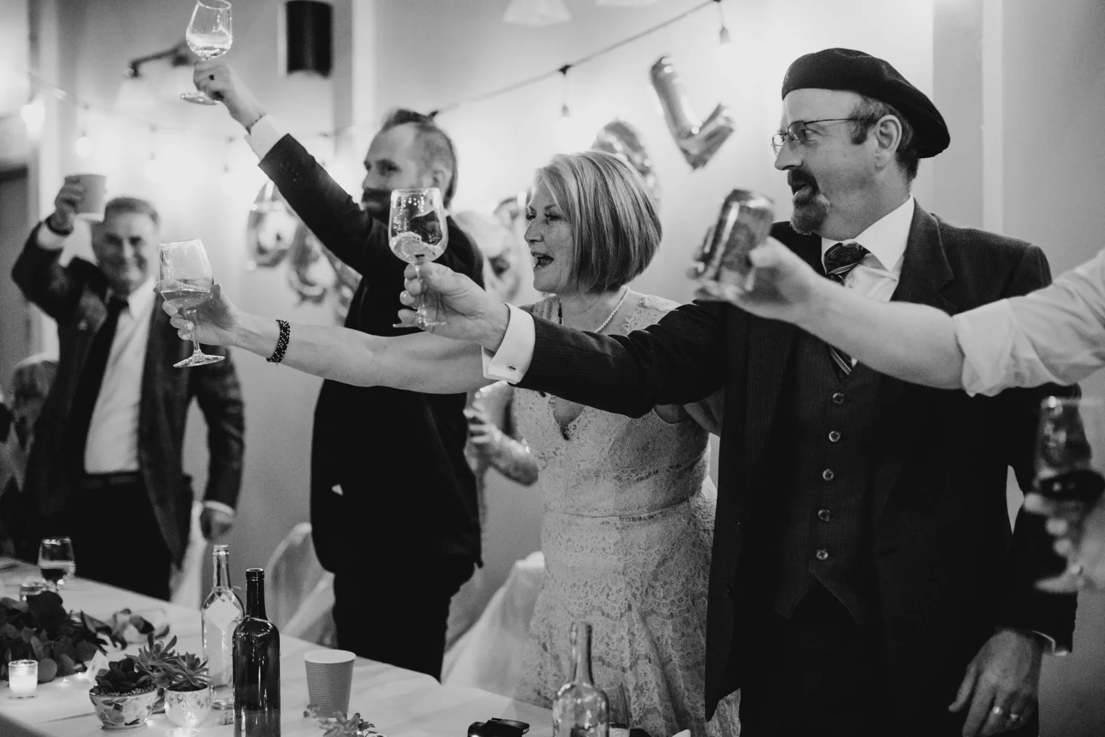 family cheers at wedding reception, victoria wedding photographer