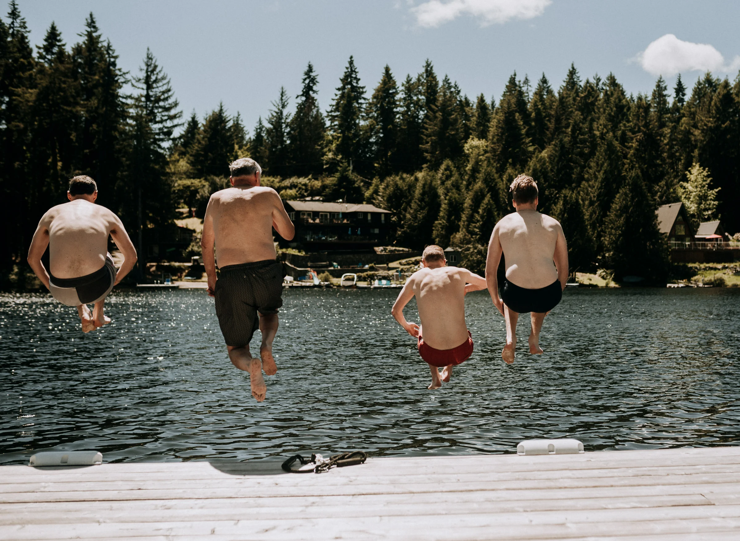groomsmen jump into lake shawnigan lake, vancouver island wedding photographer