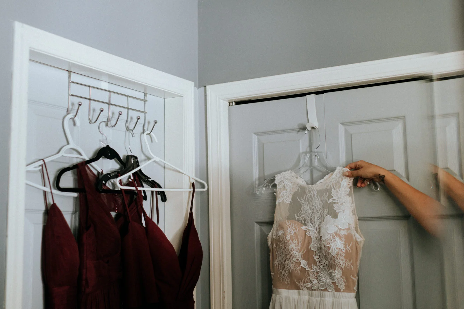 bride reaches for wedding dress Port Alberni wedding Photographer