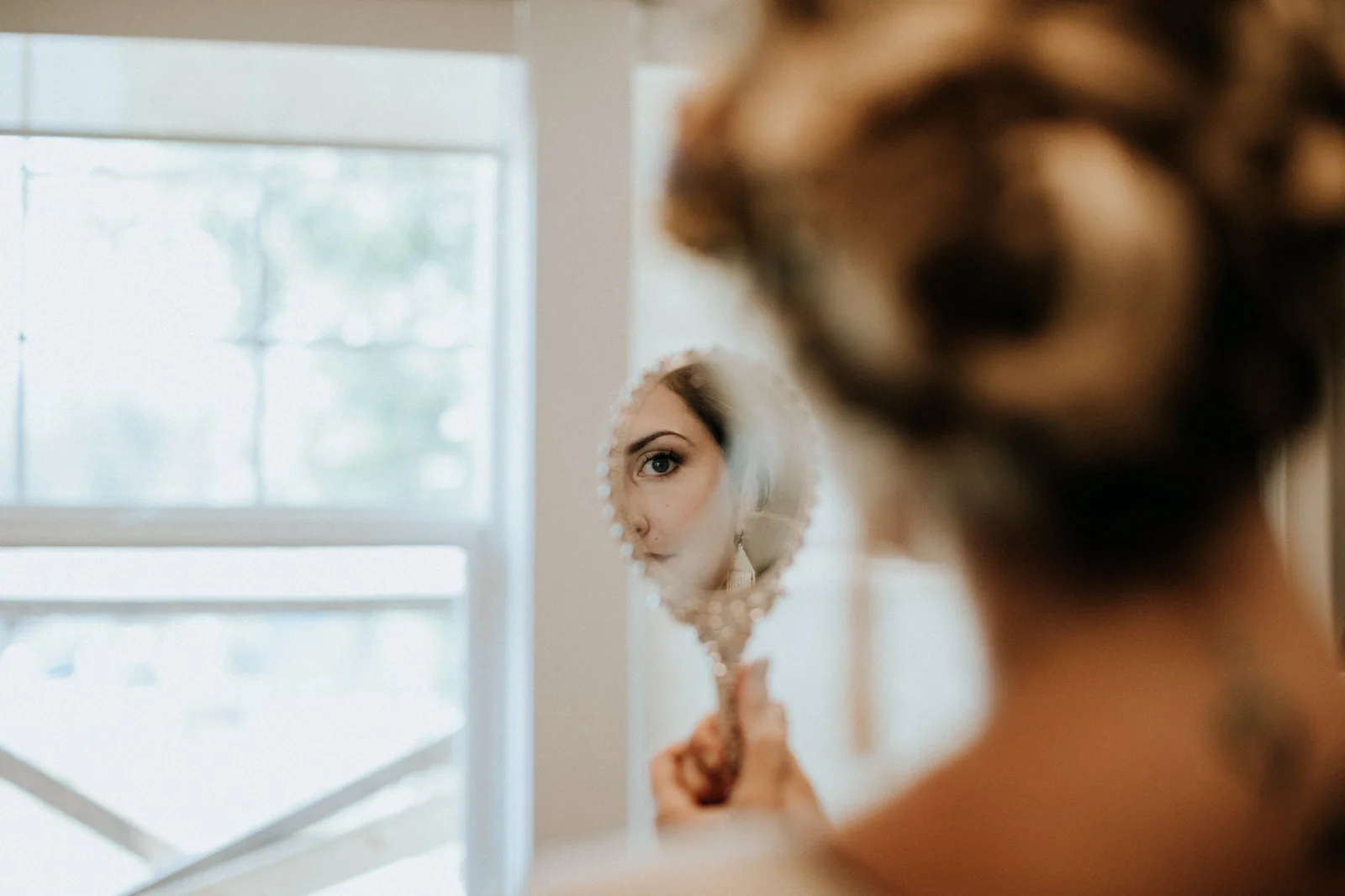 bride looks in the mirror Port Alberni Wedding