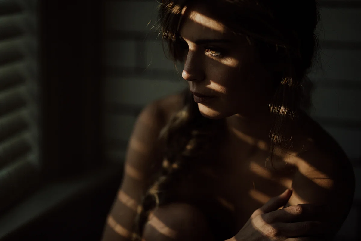 woman in window intimate portrait boudoir photographer victoria