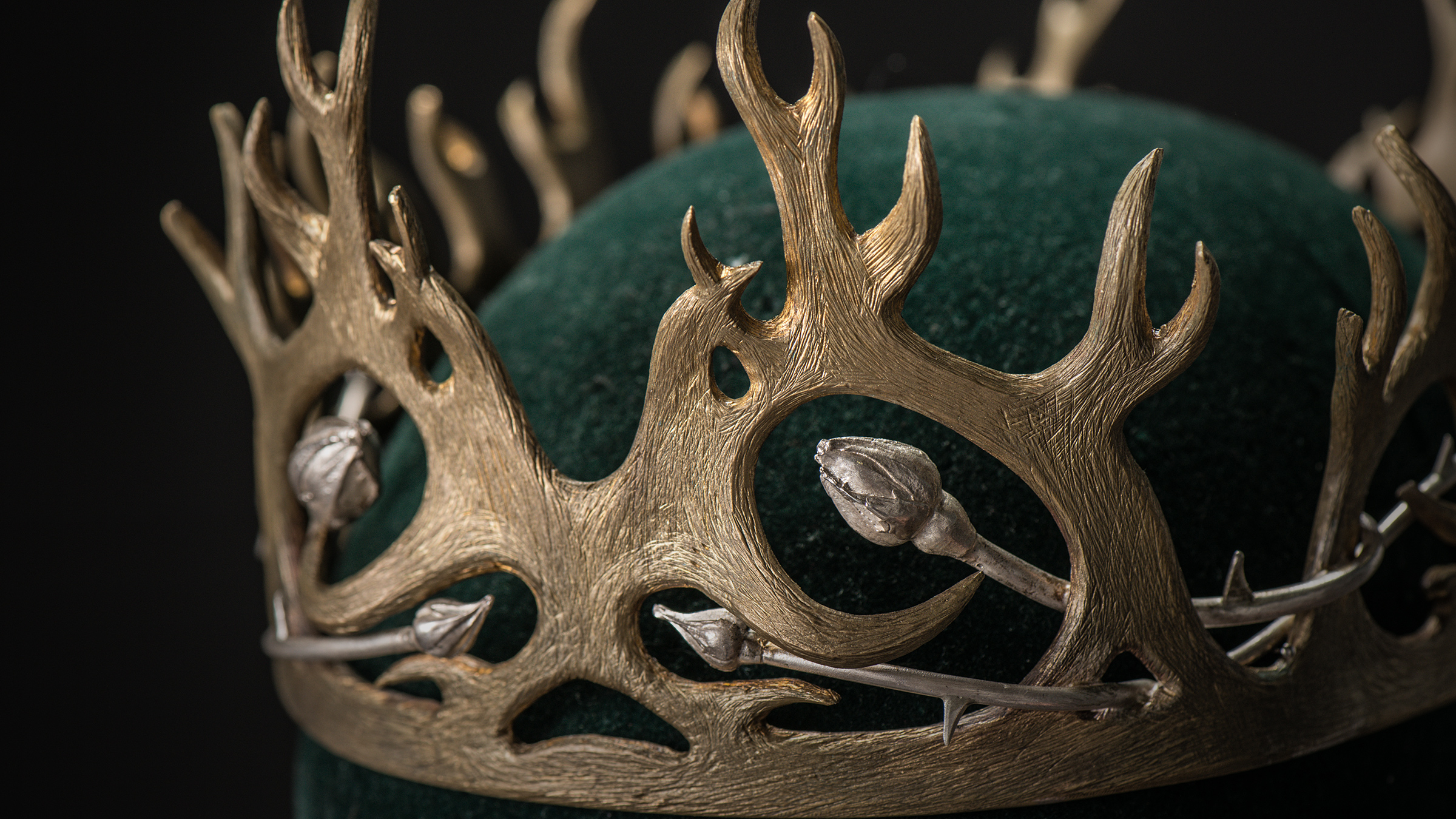 Joffrey’s crown has antlers, but roses are creeping within it. 