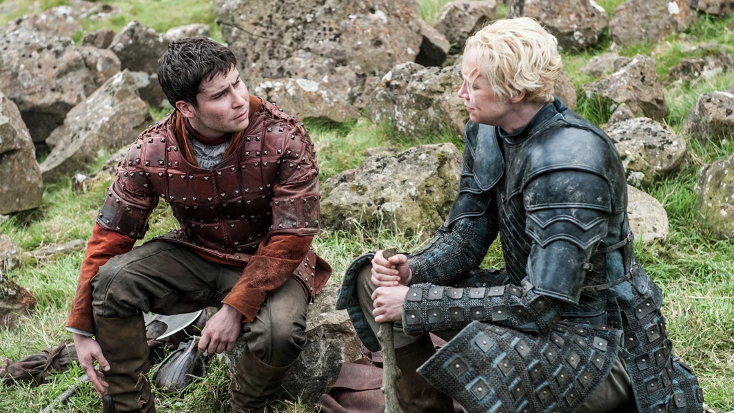 0
0
1
15
87
HBO
1
1
101
14.0
Normal
0
false
false
false
EN-US
JA
X-NONE
/* Style Definitions */
table.MsoNormalTable
{mso-style-name:"Table Normal";
mso-tstyle-rowband-size:0;
mso-tstyle-colband-size:0;
mso-style-noshow:yes;
mso-style-priority:99;
mso-style-parent:"";
mso-padding-alt:0in 5.4pt 0in 5.4pt;
mso-para-margin-top:0in;
mso-para-margin-right:0in;
mso-para-margin-bottom:8.0pt;
mso-para-margin-left:0in;
line-height:107%;
mso-pagination:widow-orphan;
font-size:11.0pt;
font-family:Calibri;
mso-ascii-font-family:Calibri;
mso-ascii-theme-font:minor-latin;
mso-hansi-font-family:Calibri;
mso-hansi-theme-font:minor-latin;}
Daniel Portman as Podrick Payne and Gwendoline Christie as Brienne of Tarth. Photo Credit: Helen Sloan/HBO