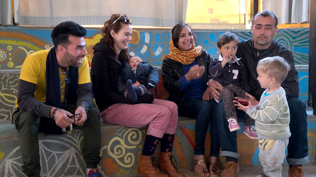 Lena Headey with a family at Kara Tepe. (Jodi Hilton/International Rescue Committee)