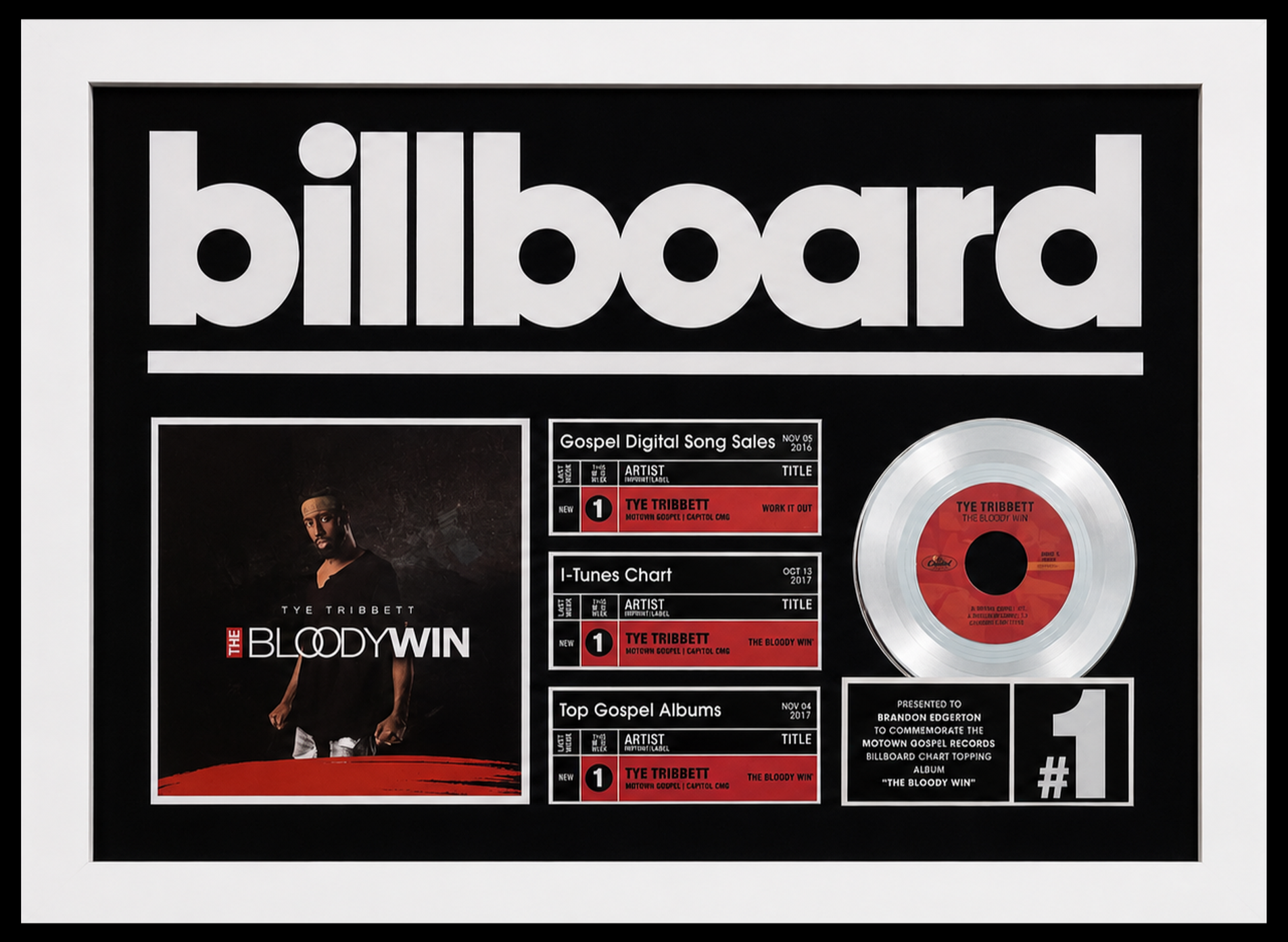 Framed platinum record award for Tye Tribbett's album 'The Bloody Win,' including chart information and a photo of Tye Tribbett. Presented to Brandon Egerton.