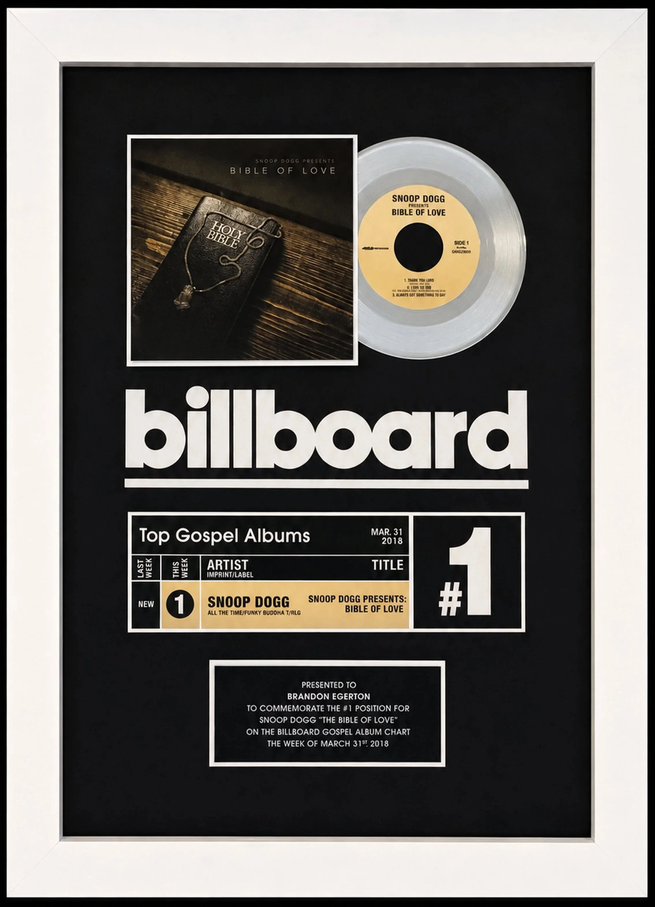 A framed billboard award plaque for Snoop Dogg's album 'Bible of Love,' featuring a silver record, a picture of the album cover, and text recognizing the album's chart achievement. Presented to Brandon Egerton.