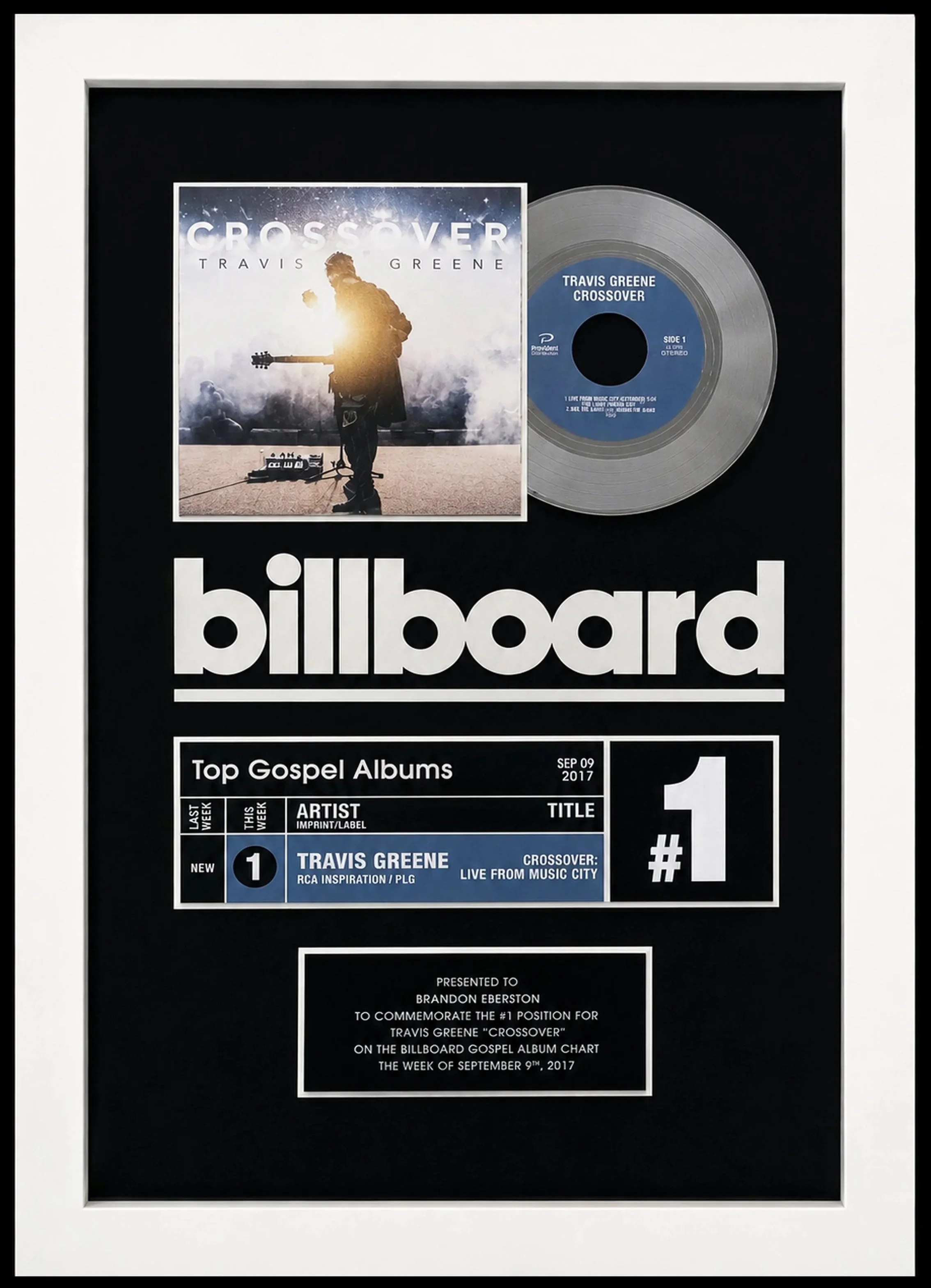 Framed Billboard chart plaque featuring Travis Greene's gospel album 'Crossover,' with a silver disc and album cover, in a black and white design with text about the album's ranking and presentation details. Presented to Brandon Egerton.